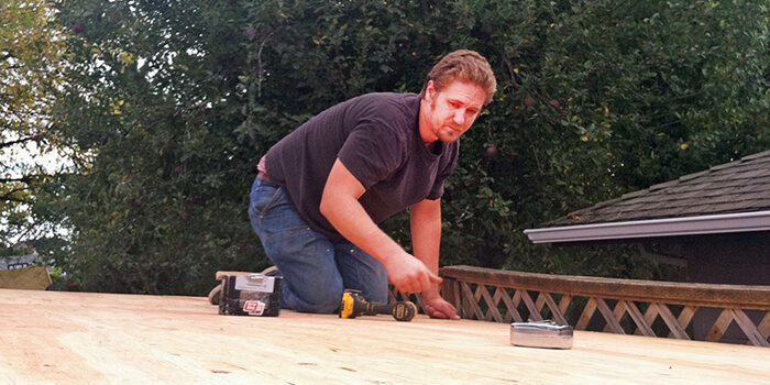Aaron Rowland working on a roof